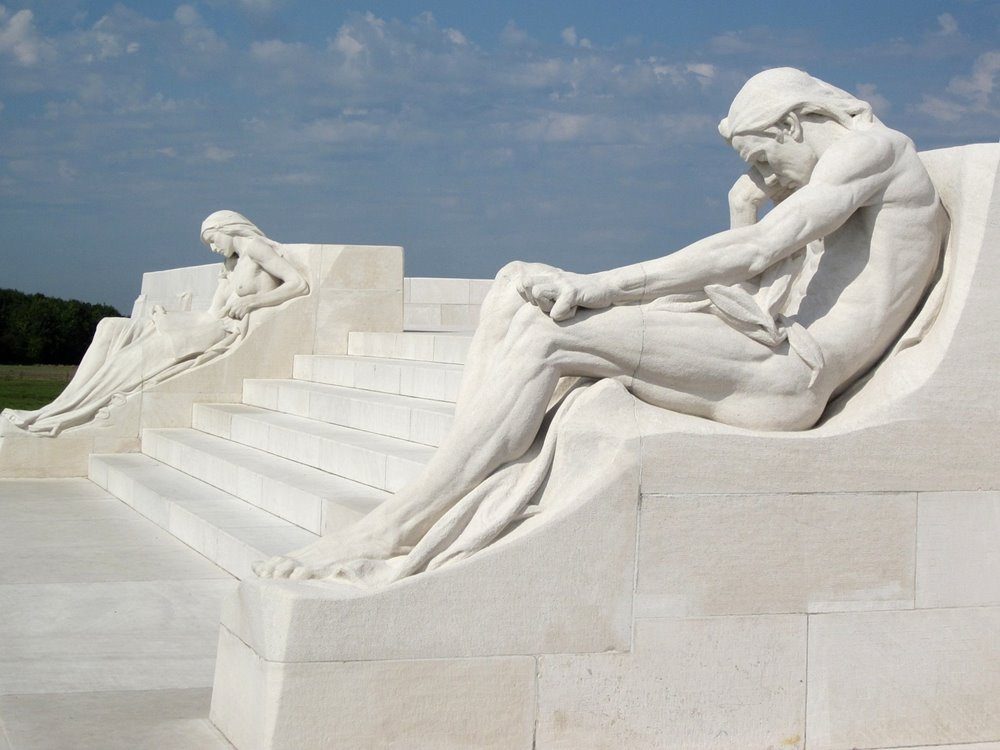 The male and female mourners reclining aside the steps of the monument.