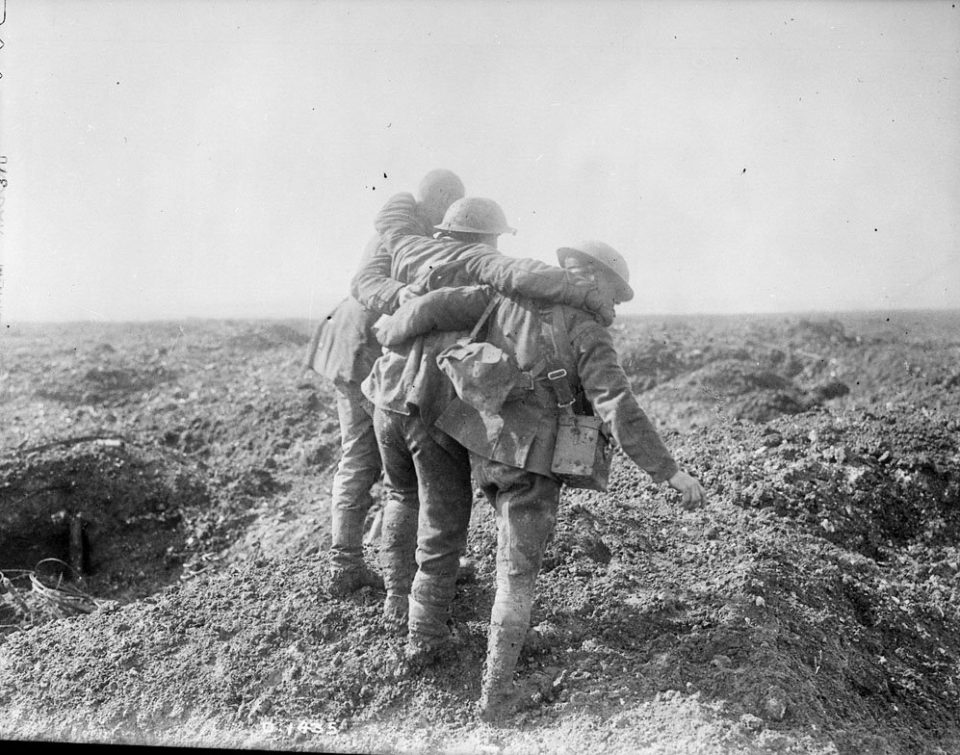 Soldiers bringing in a wounded comrade at Vimy (LAC M#3397007).
